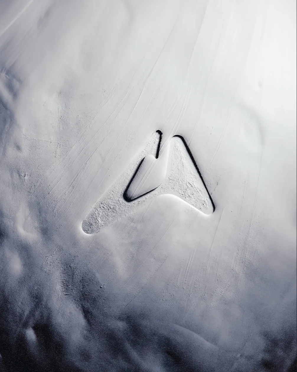 Artefact logo pressed into a soft white textured surface, brand visual by Mugdha Studios