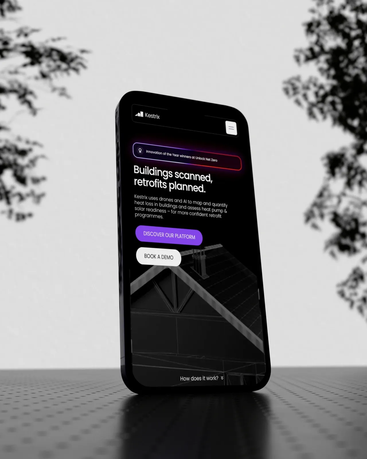 Smartphone showing the Kestrix website hero, Buildings scanned, retrofits planned, designed by Mugdha Studios