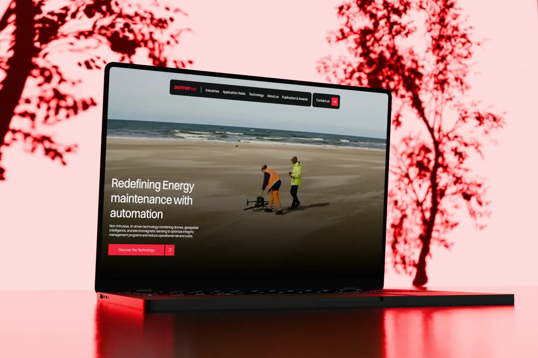 Laptop showing the Skipper NDT website on energy maintenance automation, in a red scene by Mugdha Studios