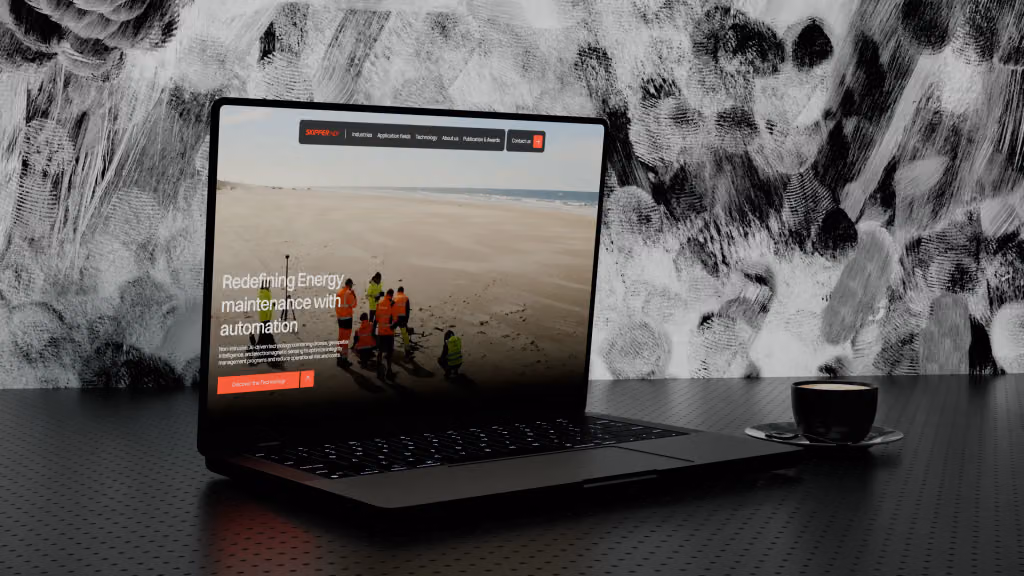 The Skipper NDT website open on a laptop: a field crew in hi-vis on a beach under “Redefining energy maintenance with automation”