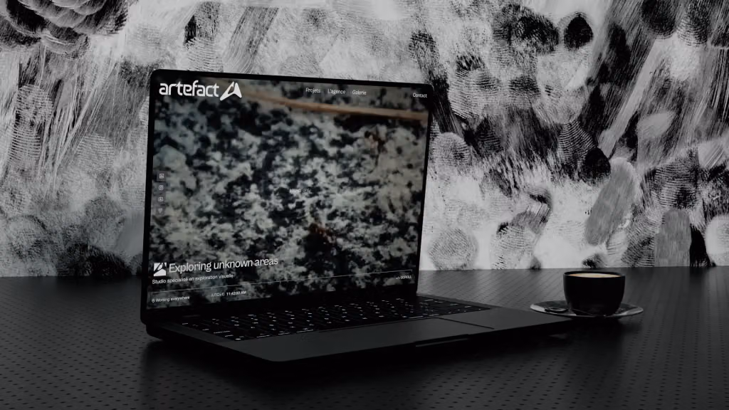 The Artefact website open on a laptop, a close-up of textured stone under the line “Exploring unknown areas”