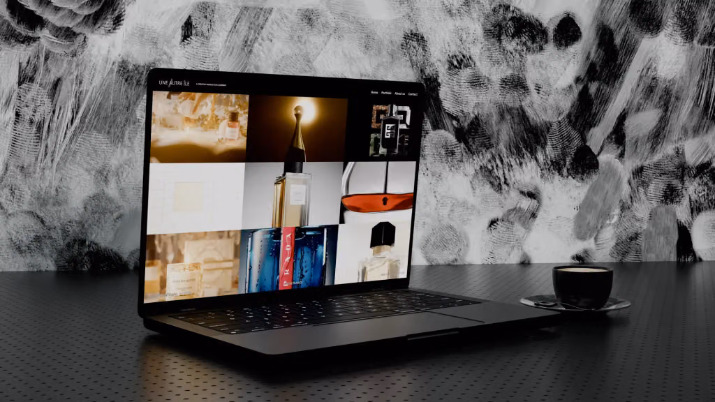 The Une Autre Île Productions website open on a laptop: a grid of perfume and luxury advertising stills