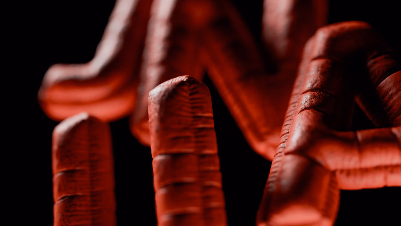 Close-up of the red, ribbed 3D letters of the Junca logo on black